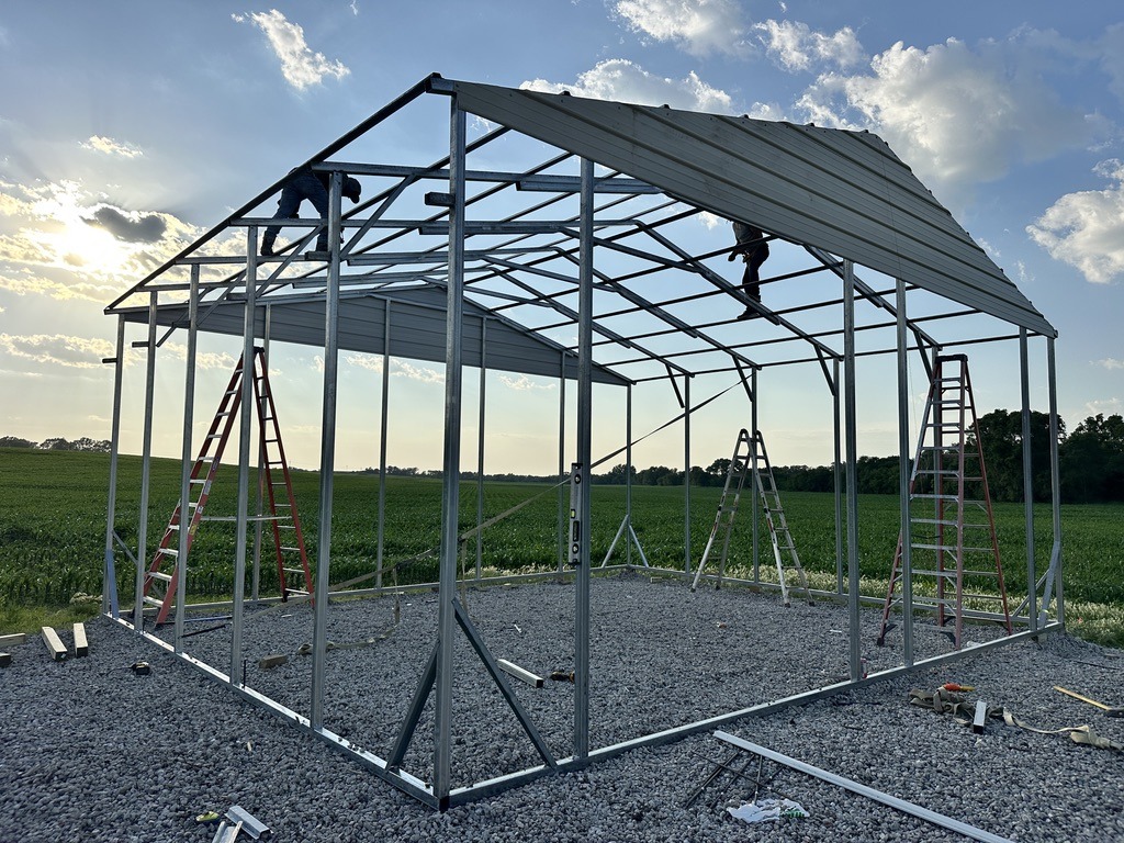 Crew in the process of constructing a large building, only the skeleton is in place.