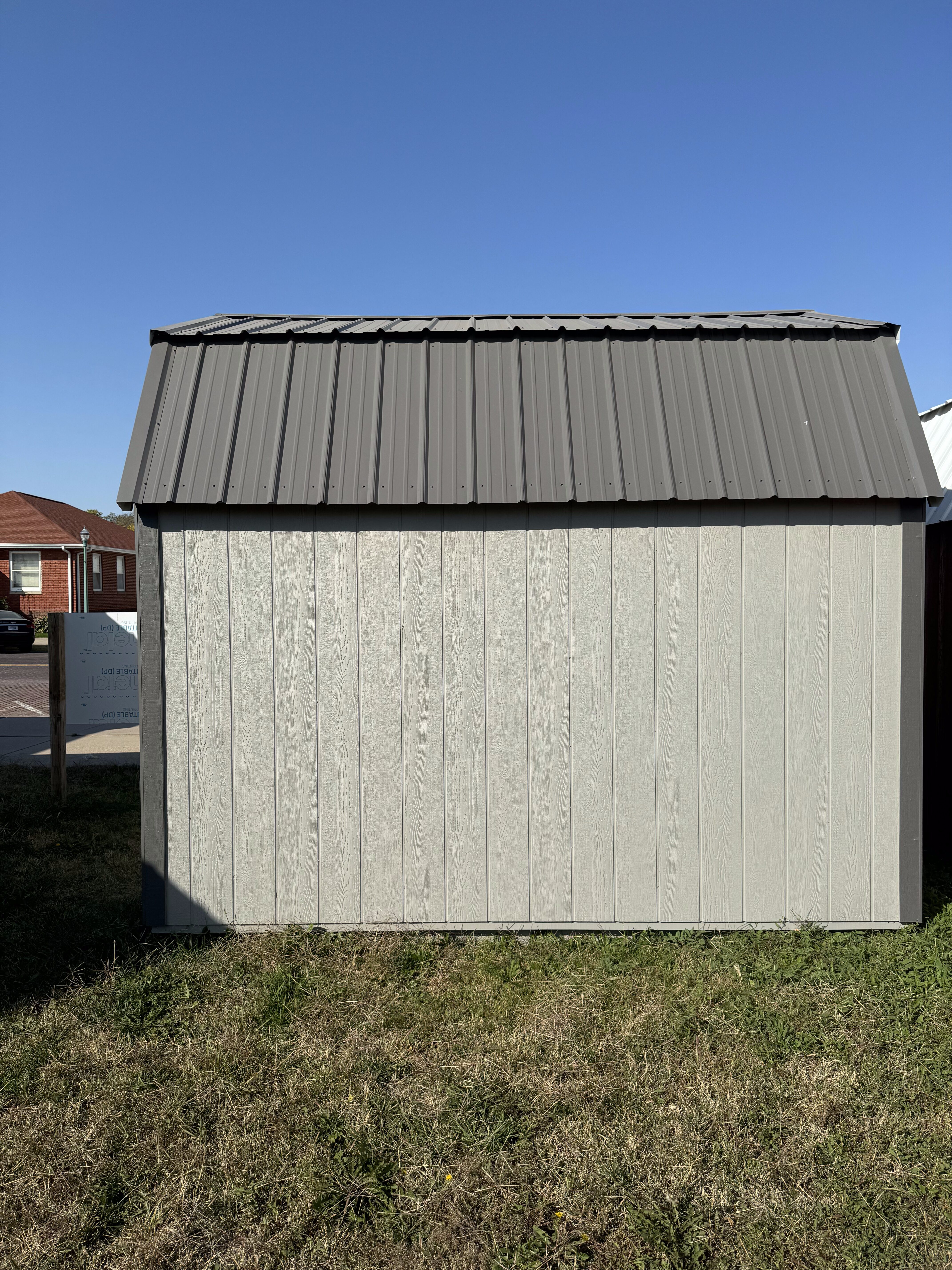 Exterior of shed showing painted wall and metal roof