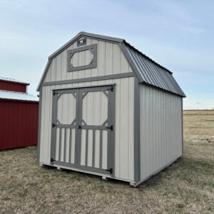 Exterior of a barn-style shed with double doors on the front of the lofted shed.