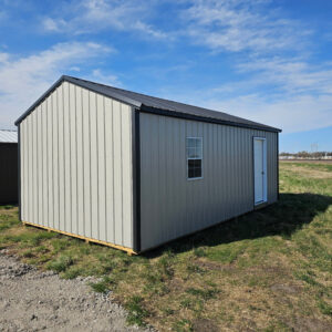 Exterior of the back of a garage showcasing a window and side door