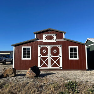 Exterior of classic looking red barn with white accents.