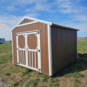 Exterior of small, double door utility shed with white trim