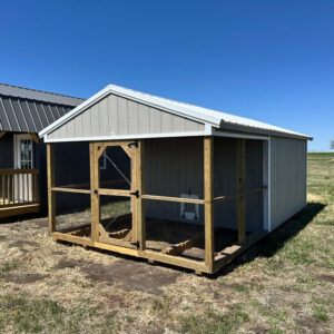 Exterior of chicken coop showcasing front portion covered with chicken wire.