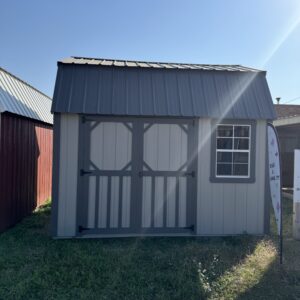 Exterior of double-door shed with a small window