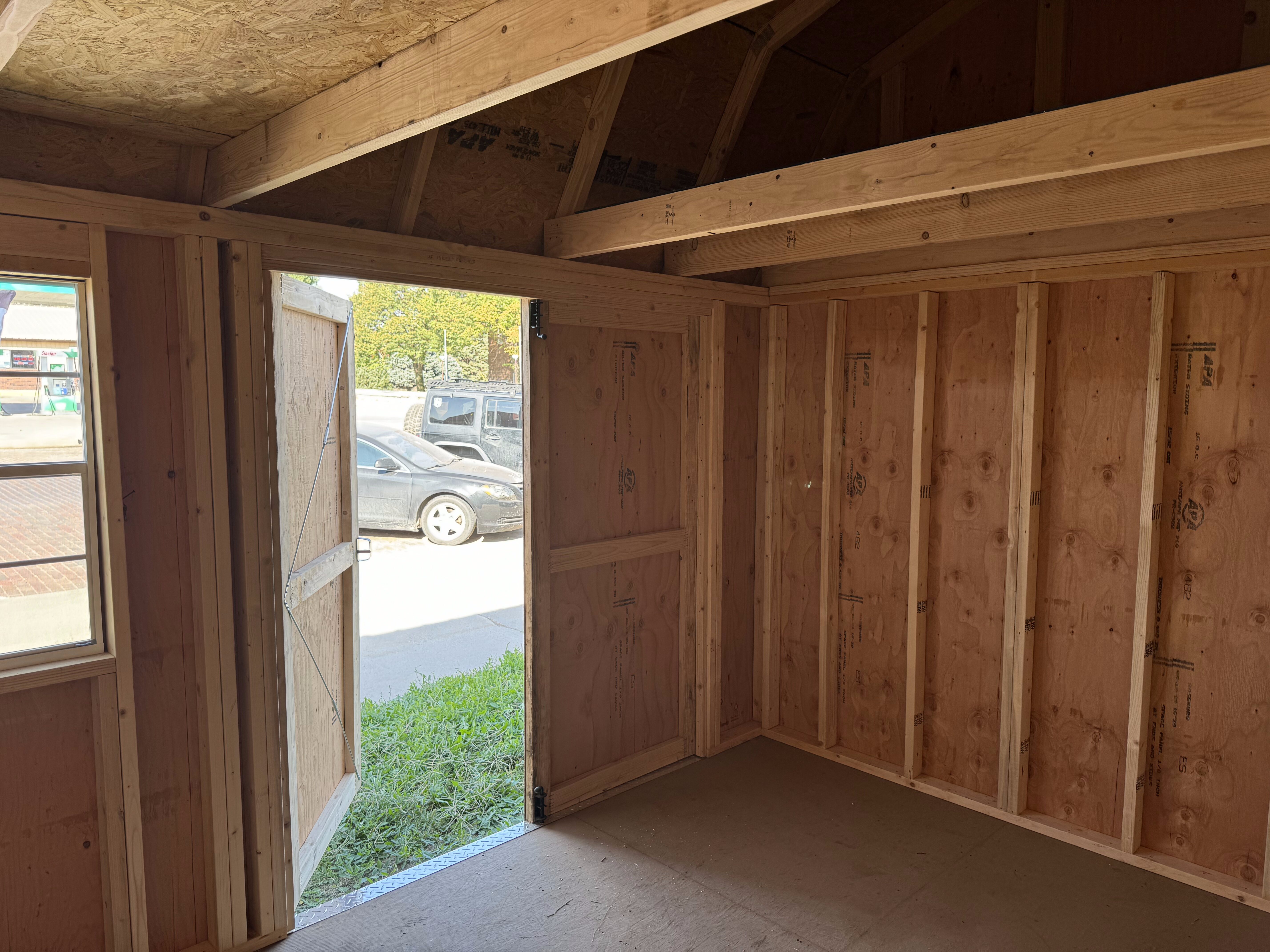 Interior view of shed looking out of the double doors.