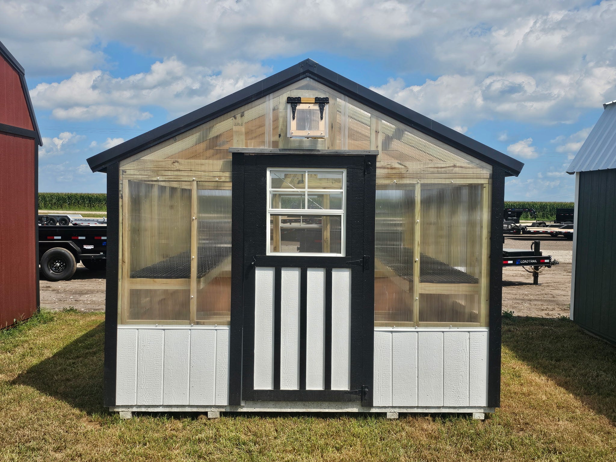 Exterior of a greenhouse, showcasing the front.