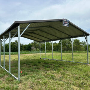 Exterior showing large carport in the grass.