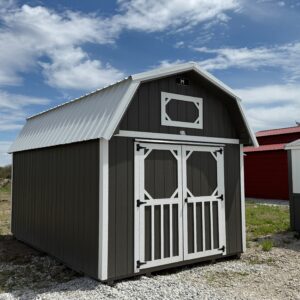 Exterior of small barn-shaped shed. Showcasing the double door front with a small loft window