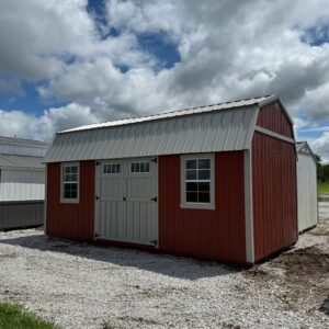 Exterior of red and white shed, showcasing shed doors and window.