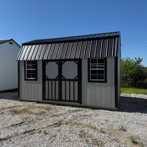 Exterior of large garden shed showcasing two windows.