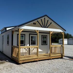 Exterior view of a large white cabin with a lumber front porch.