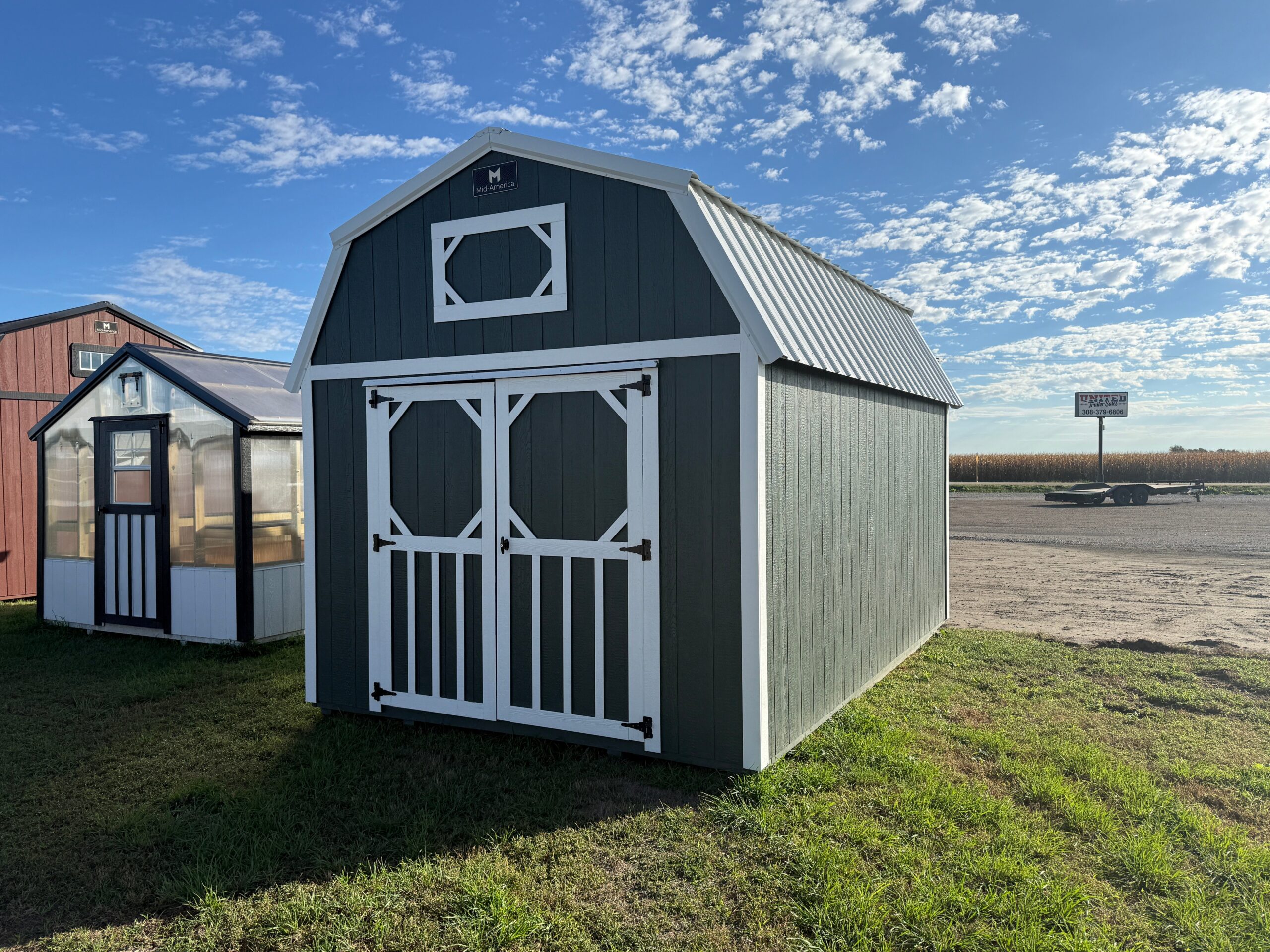 Exterior of barn-styled shed showcasing large doors.