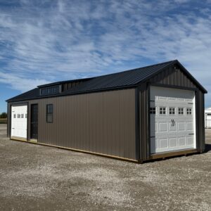 Exterior of garage showcasing the front door and garage door.
