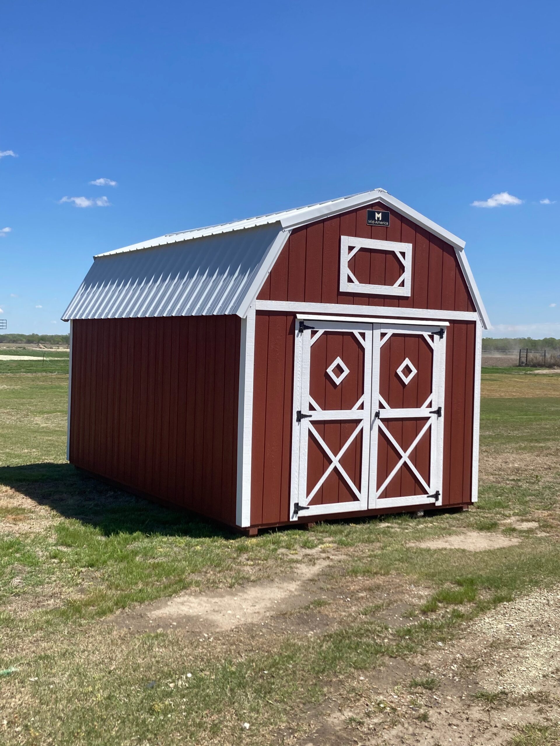 Exterior of a small, barn-styled shed.
